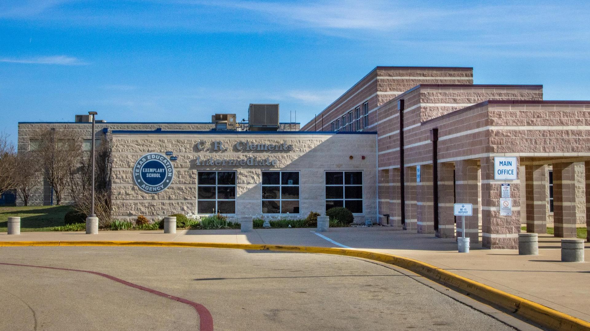 Entrance of C. P. Clemens Elementary School with blue sky and landscaped area.
