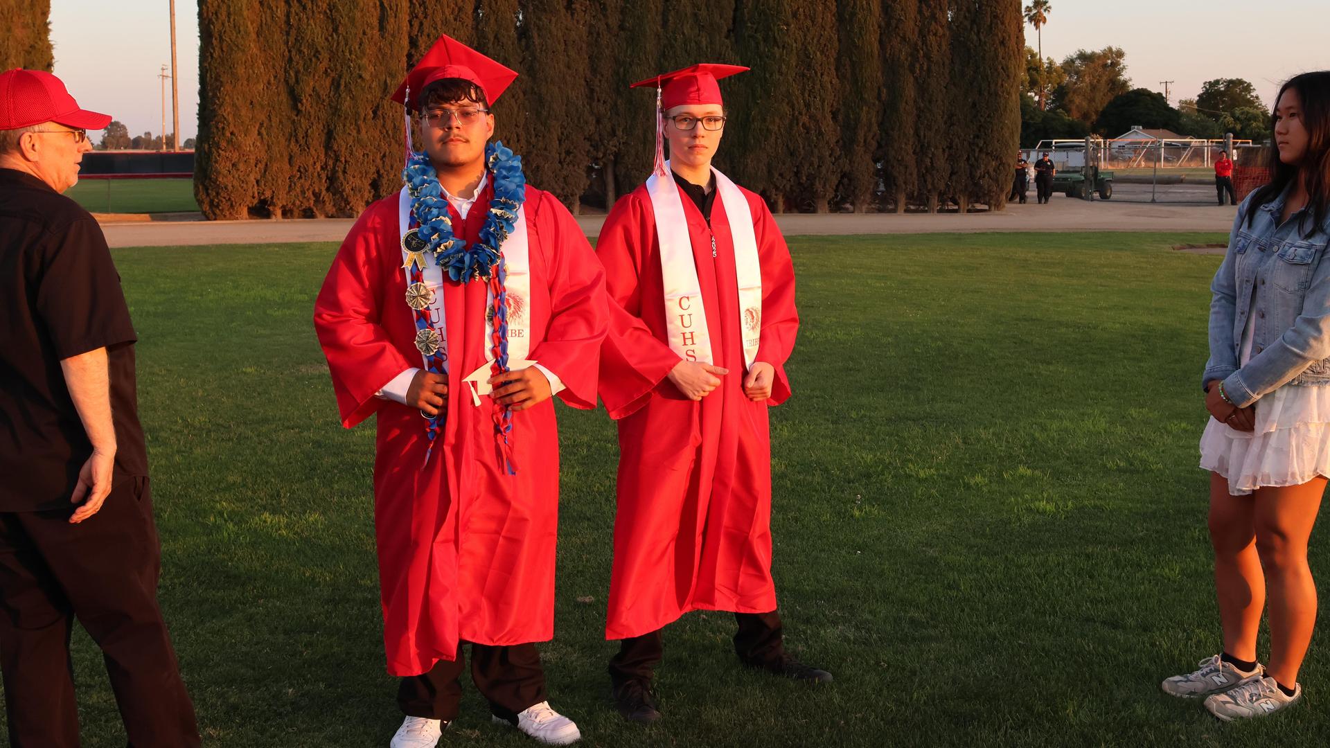 Mr. Galloway and Euhna song positioning seniors to be photographed