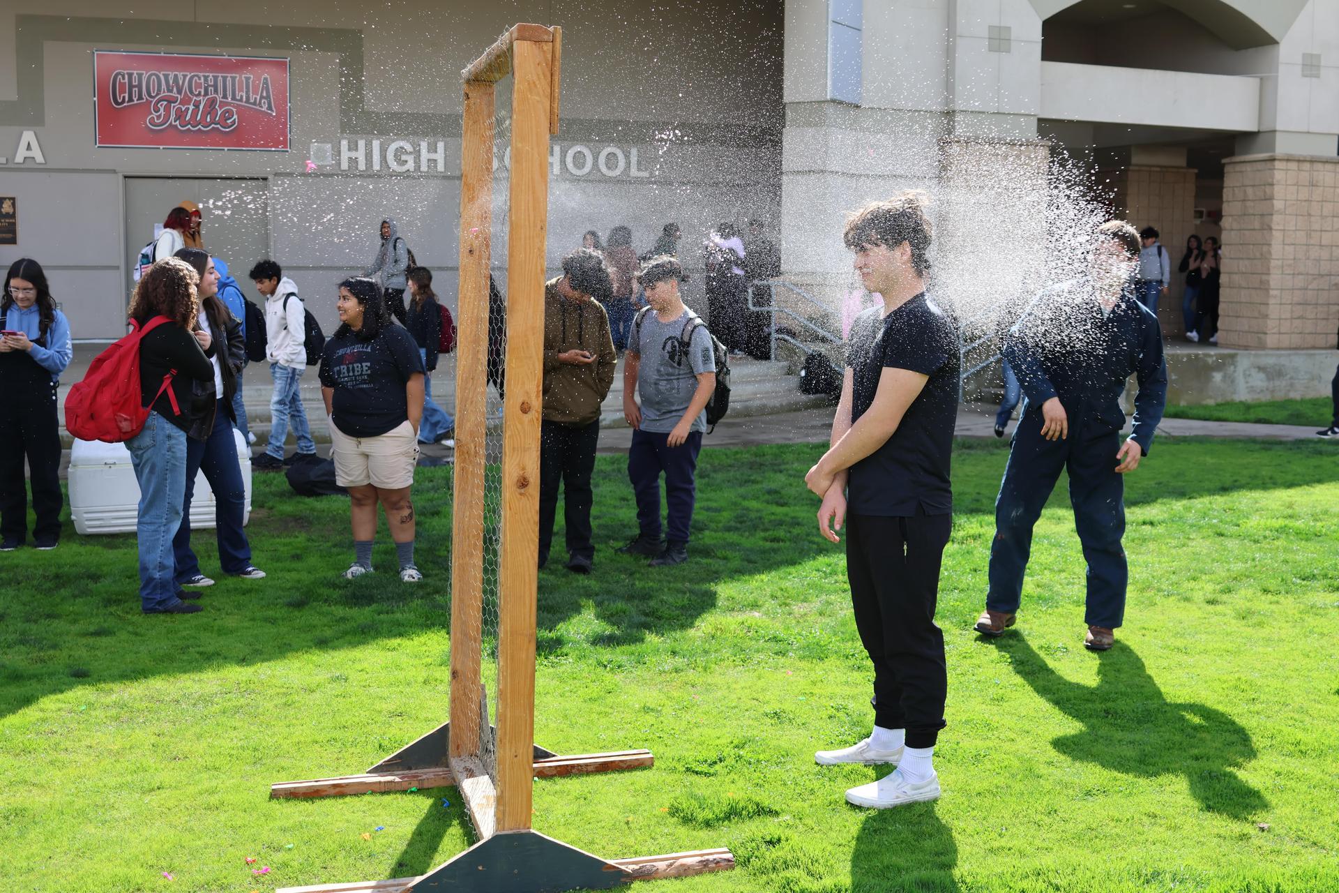 students and staff enjoying the water balloon toss