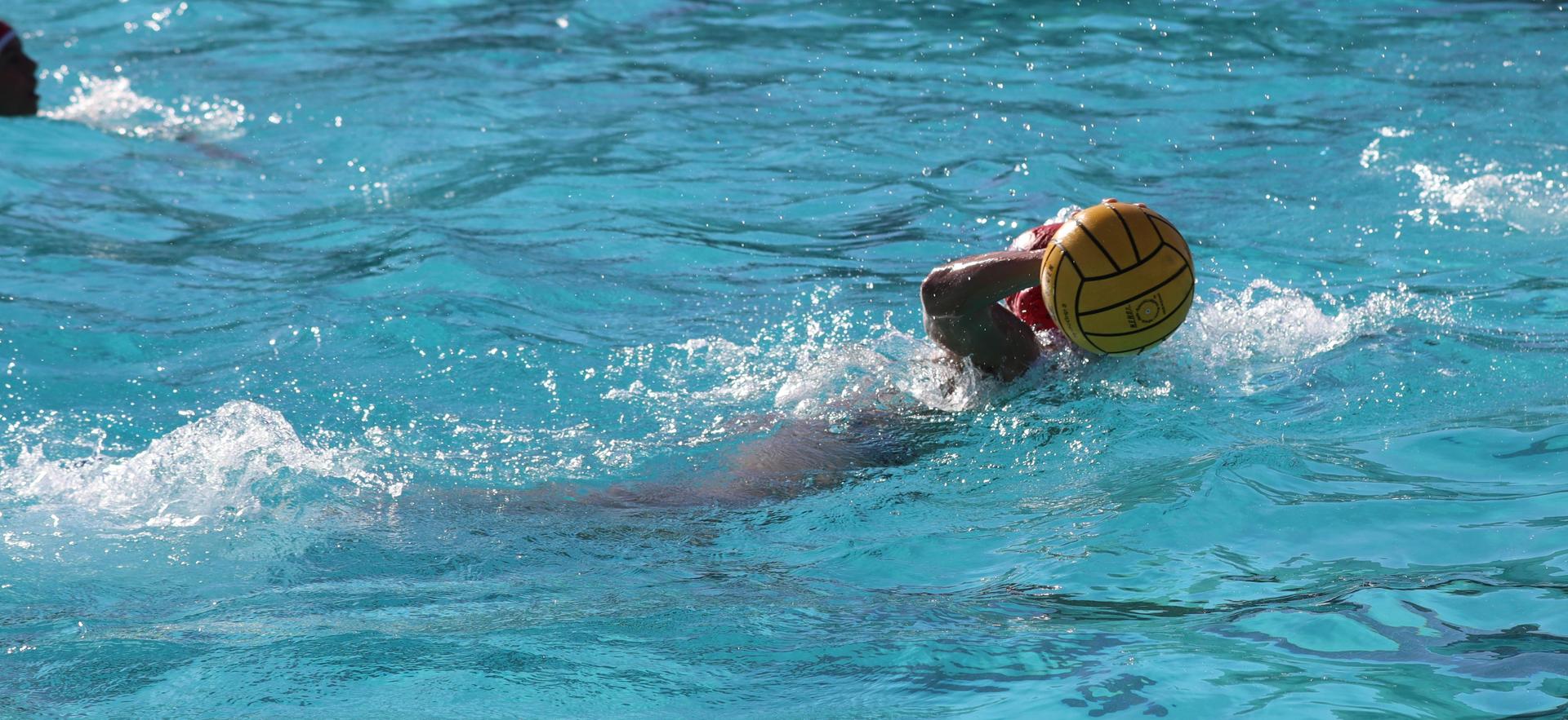 boys water polo players in action against hoover
