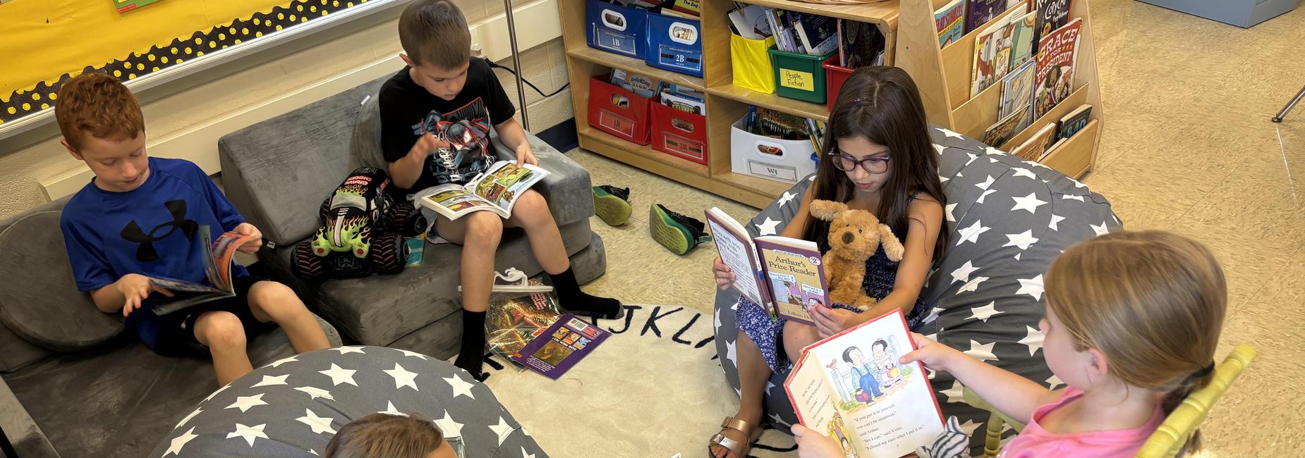 students reading to their stuffed animals