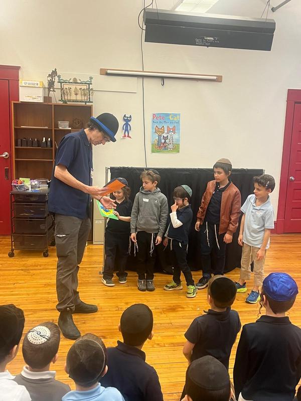 Students get ready to perform with their paper puppets.