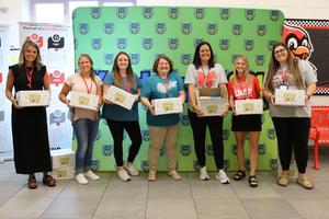 Fourth grade teacher receive boxes of school supplies for their students.