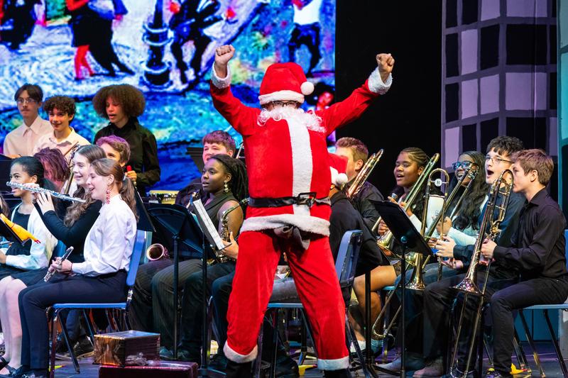 Santa appears on stage with the concert band
