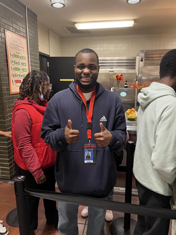 Student smiles while in line for lunch