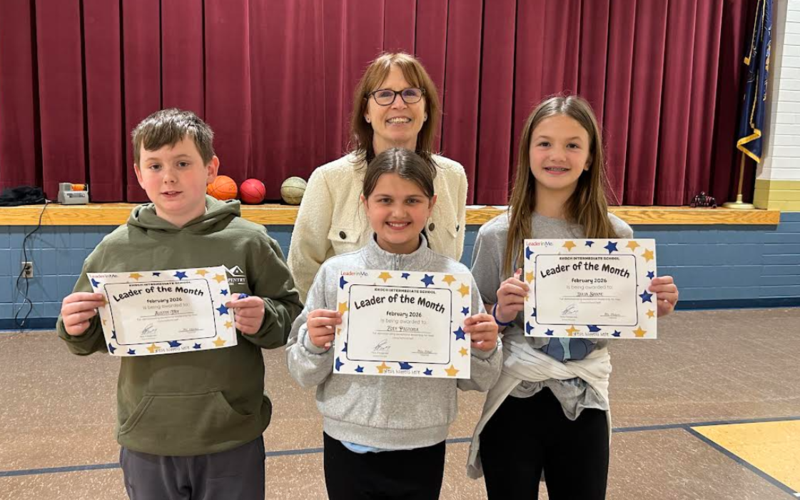 principal with three students holding certficates