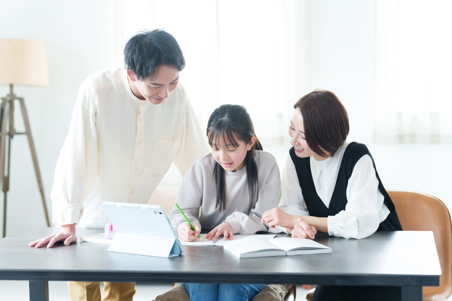 Parents helping daughter with homework