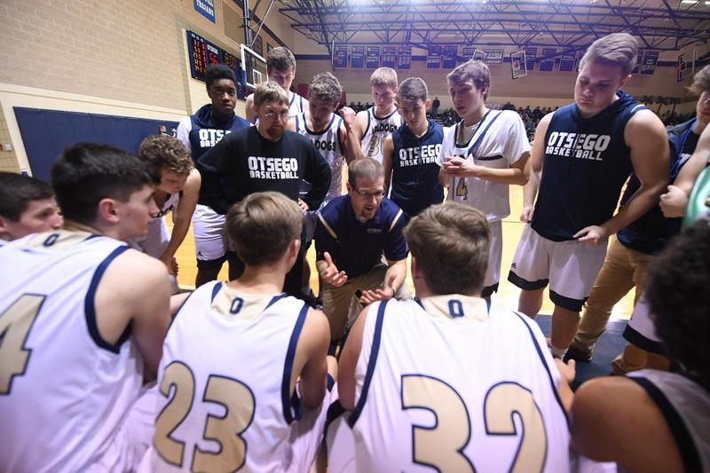 Coach Dennis talks to the team during a time out