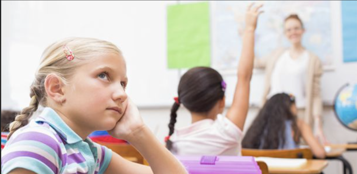 Young girl is distracted and not paying attention in a classroom