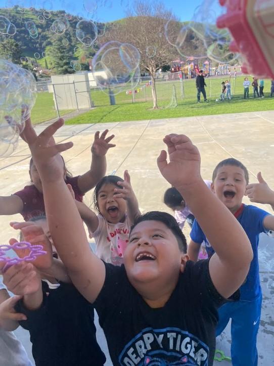 Students enjoying bubbles