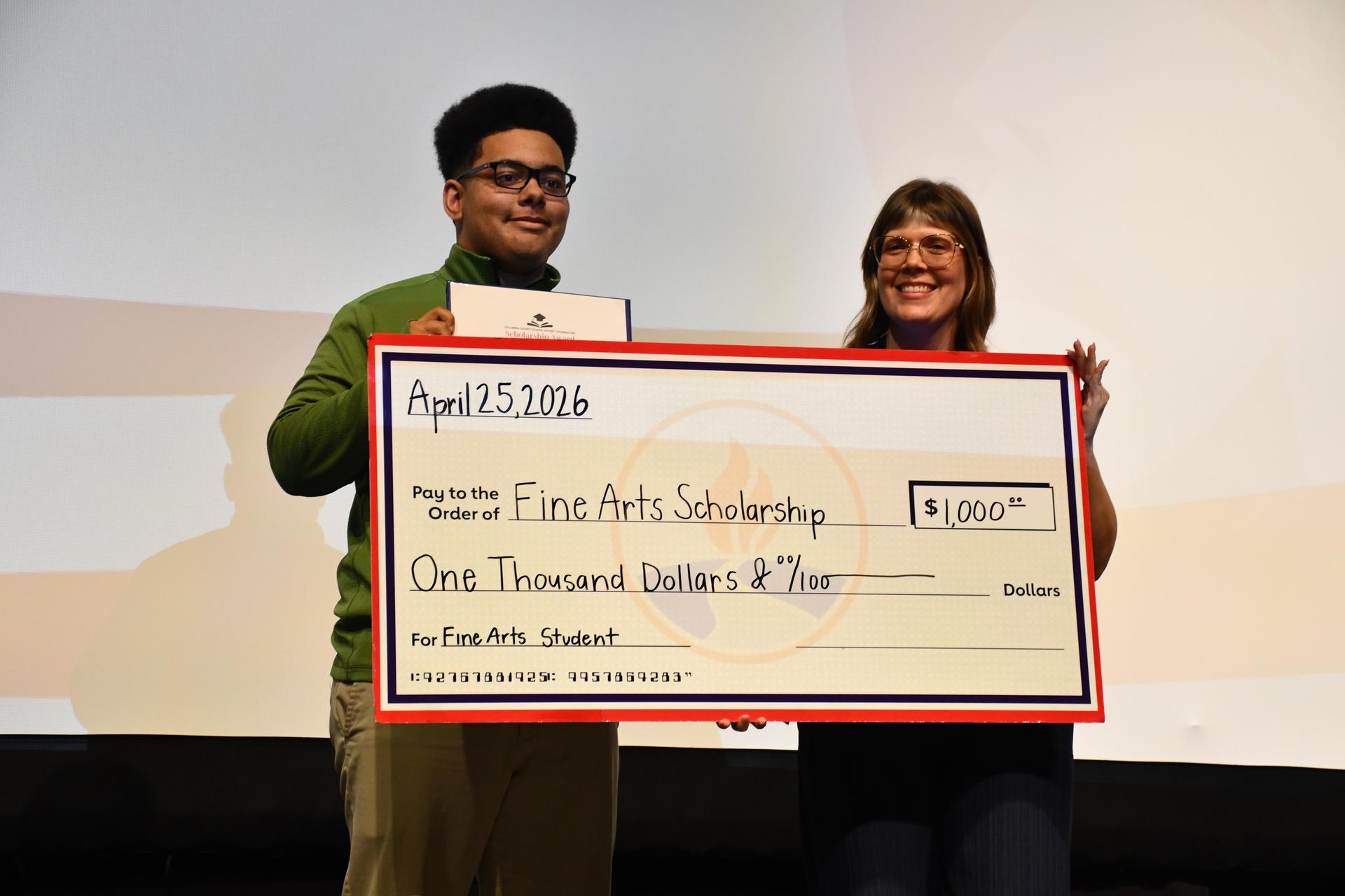 people holding large check