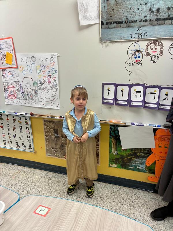 a boy shows his costume