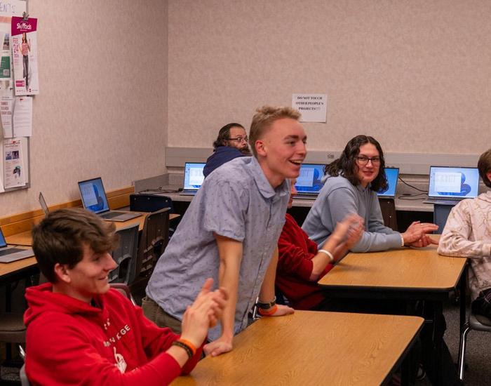 student in classroom being celebrated