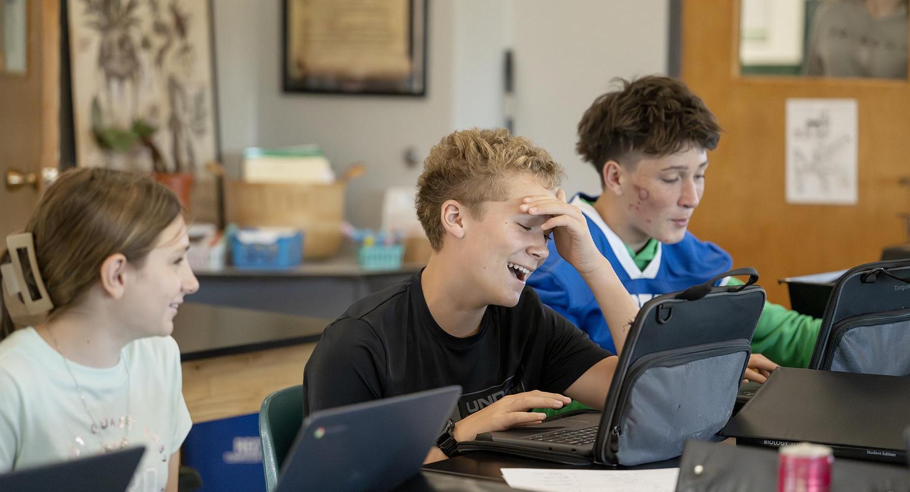 Students work on laptops.