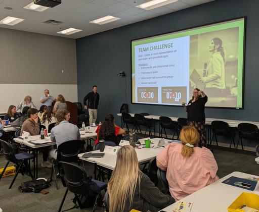 Participants engaging in a team challenge during a workshop.