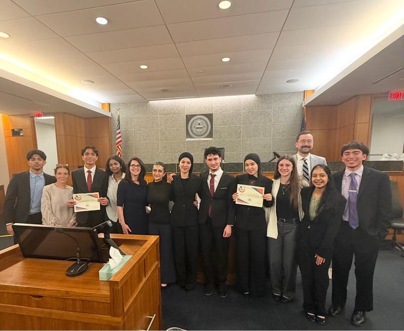 Image of the mock trial team standing in the courtroom