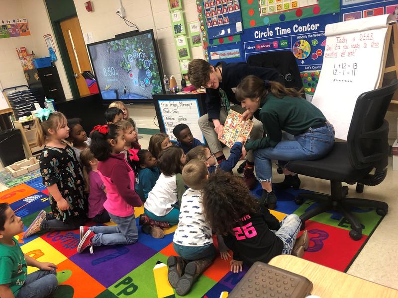 older students read aloud to group of younger students