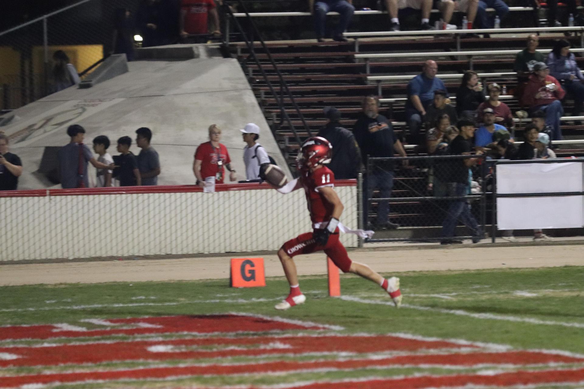 varsity football players in action against Riverdale
