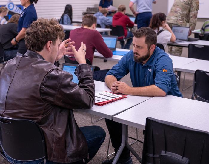 teacher instructing student