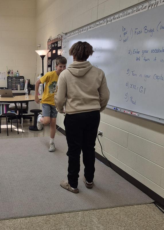Students act out scenes using the meaning of a word