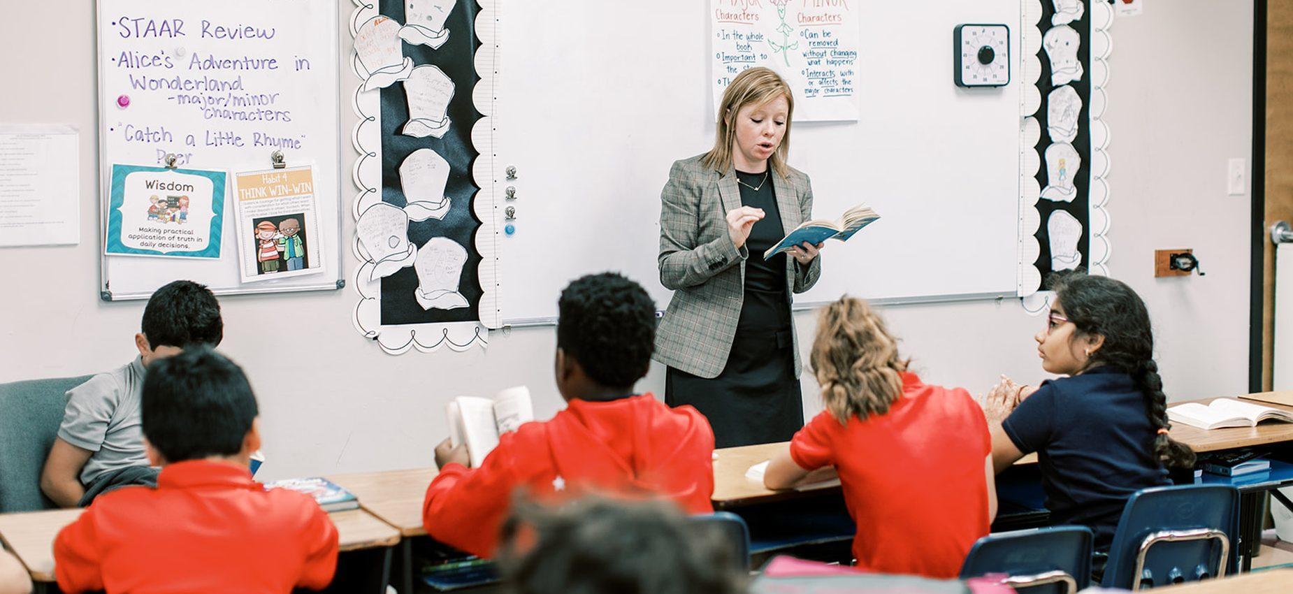 A Coppell Classical Academy teacher reads aloud to her class during a lesson
