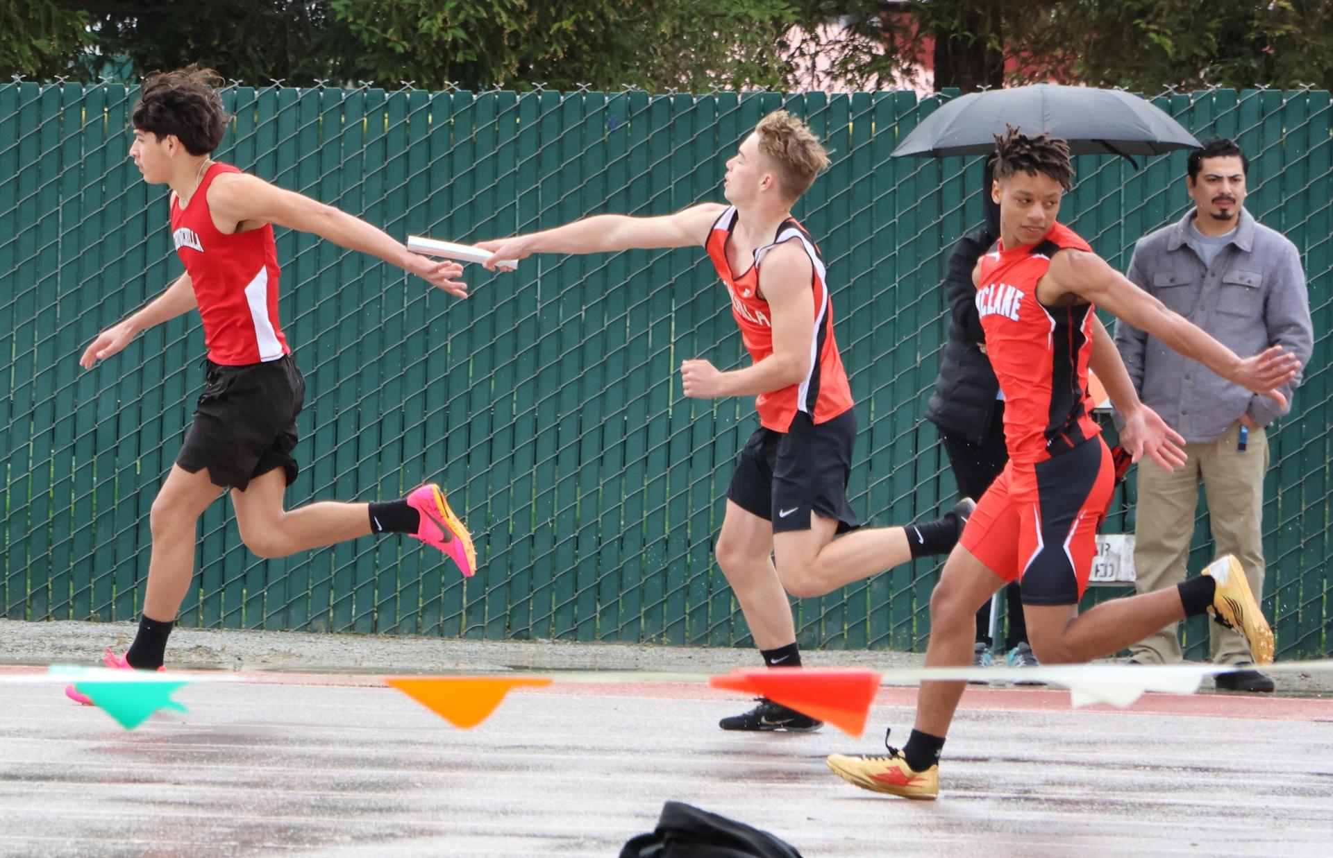 junior varsity boys running the four by 100 meter relay