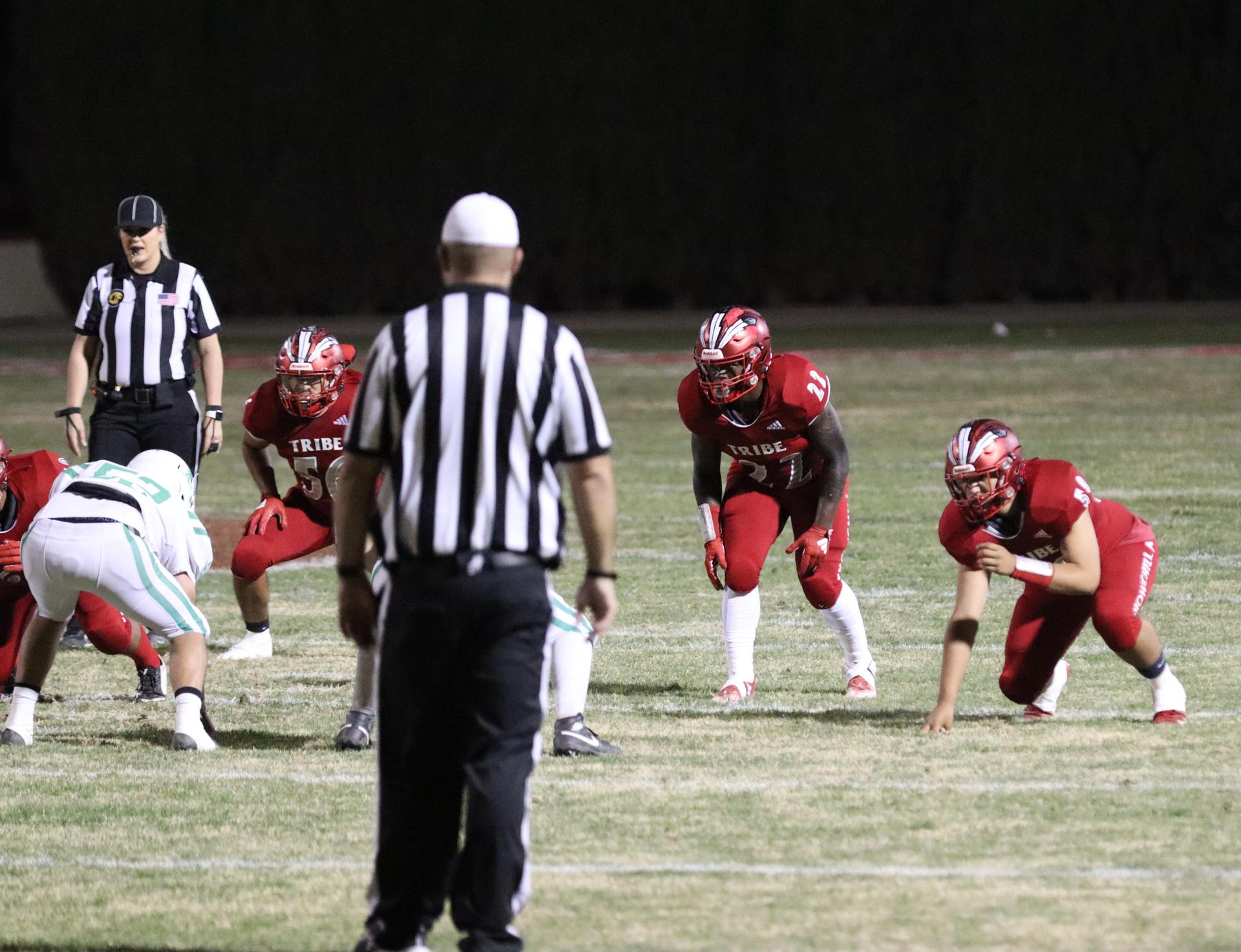 varsity football players in action against Riverdale