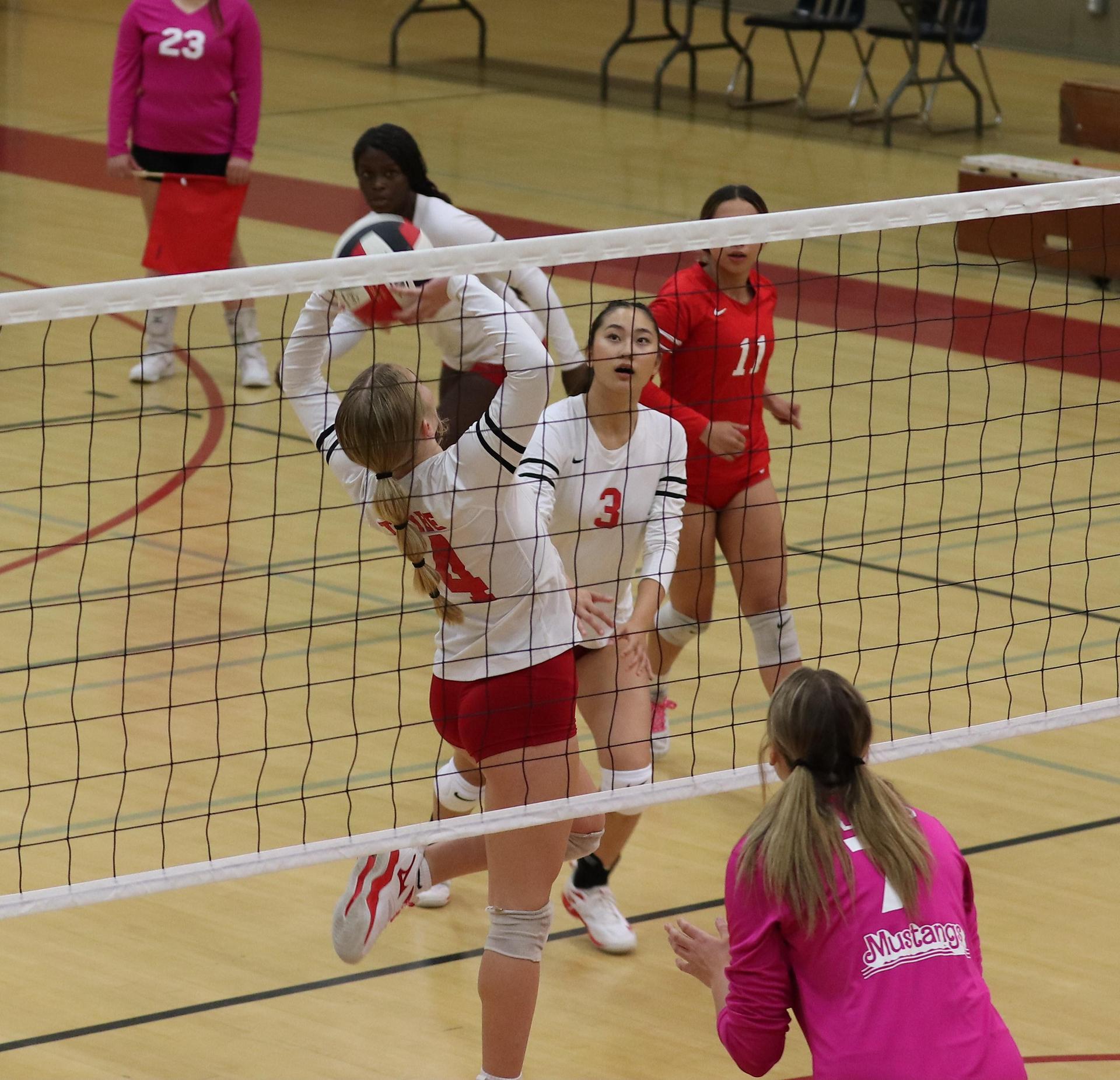varsity volleyball players in action against Minarets