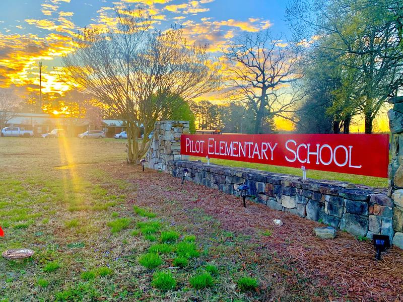 A picture of Pilot's main sign at sunrise.