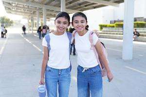 Two girls with arms around each other on the first day of school