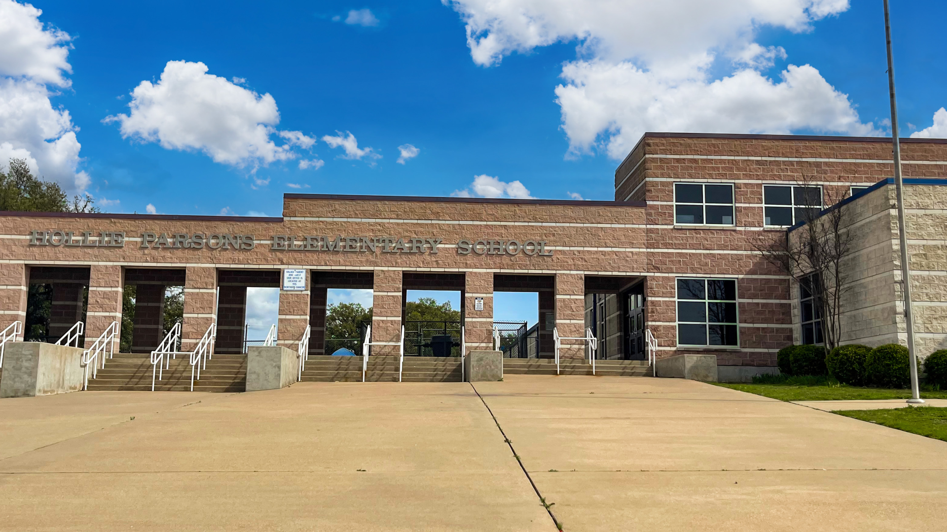 Front view of Hollie Parsons Elementary School under a blue sky with clouds.