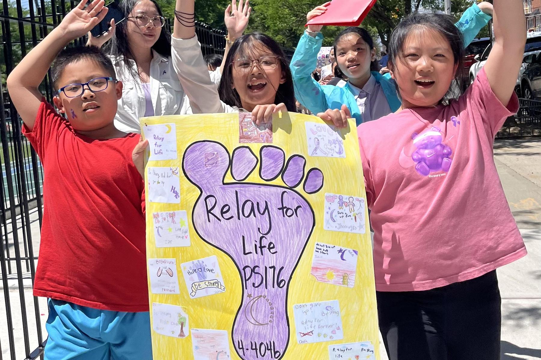 Children holding a colorful poster for Relay for Life, smiling and waving.