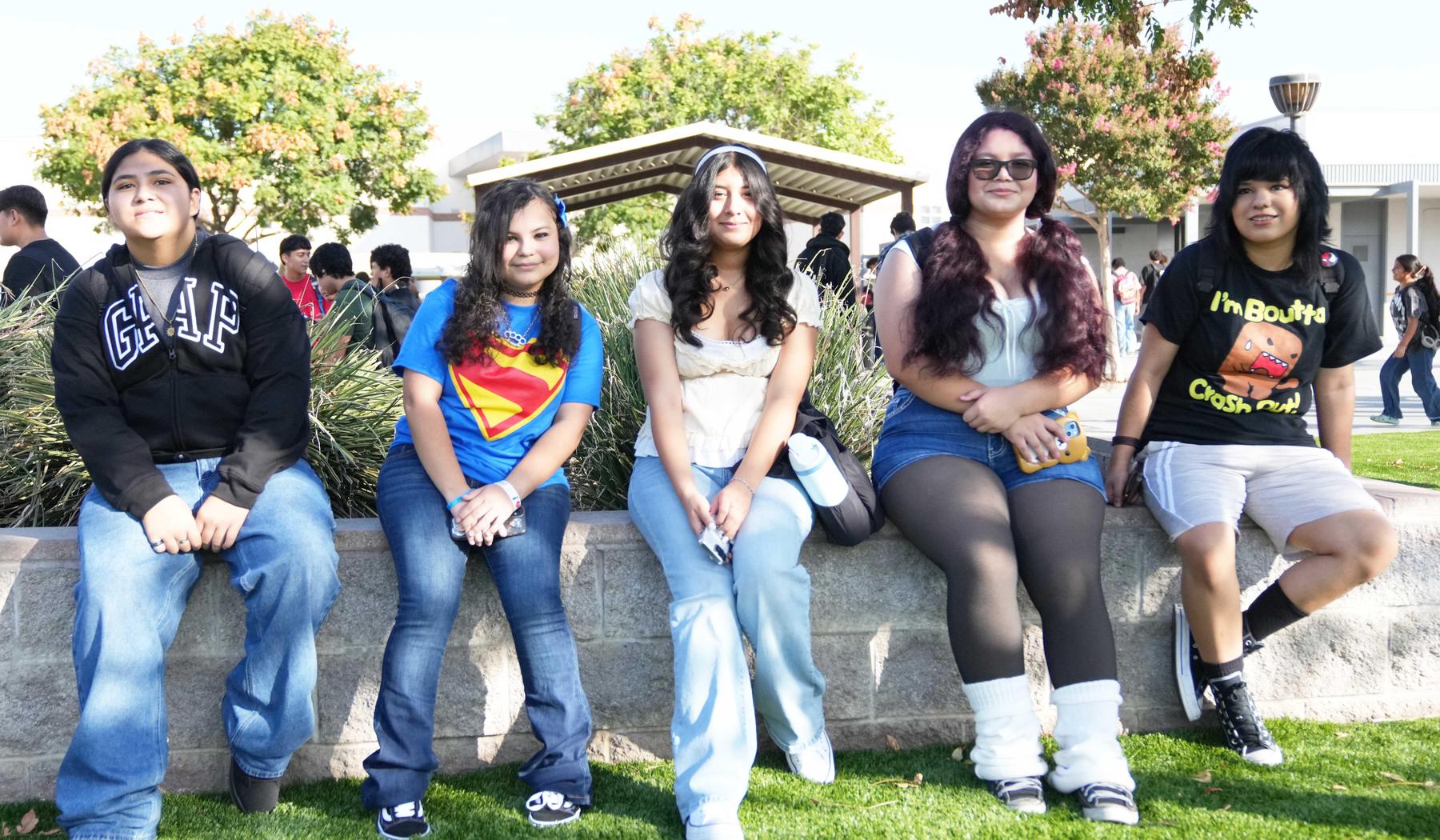 Group of girls sitting on concrete wall on the first day of school