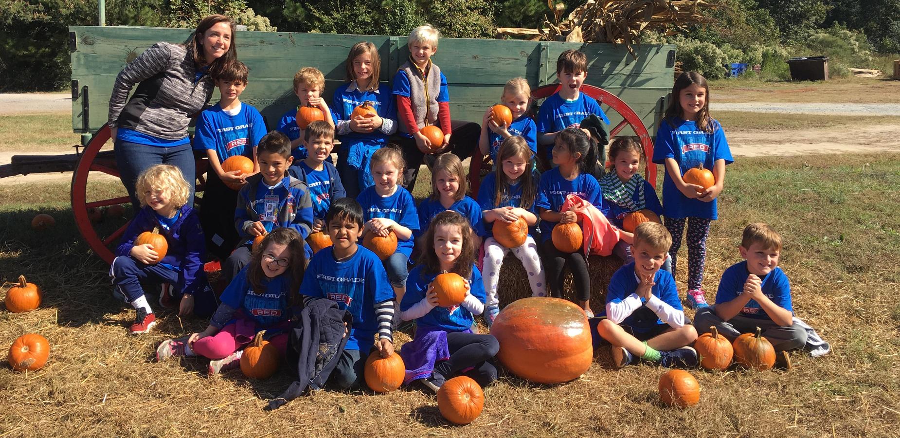 Students with pumpkins on farm field trip