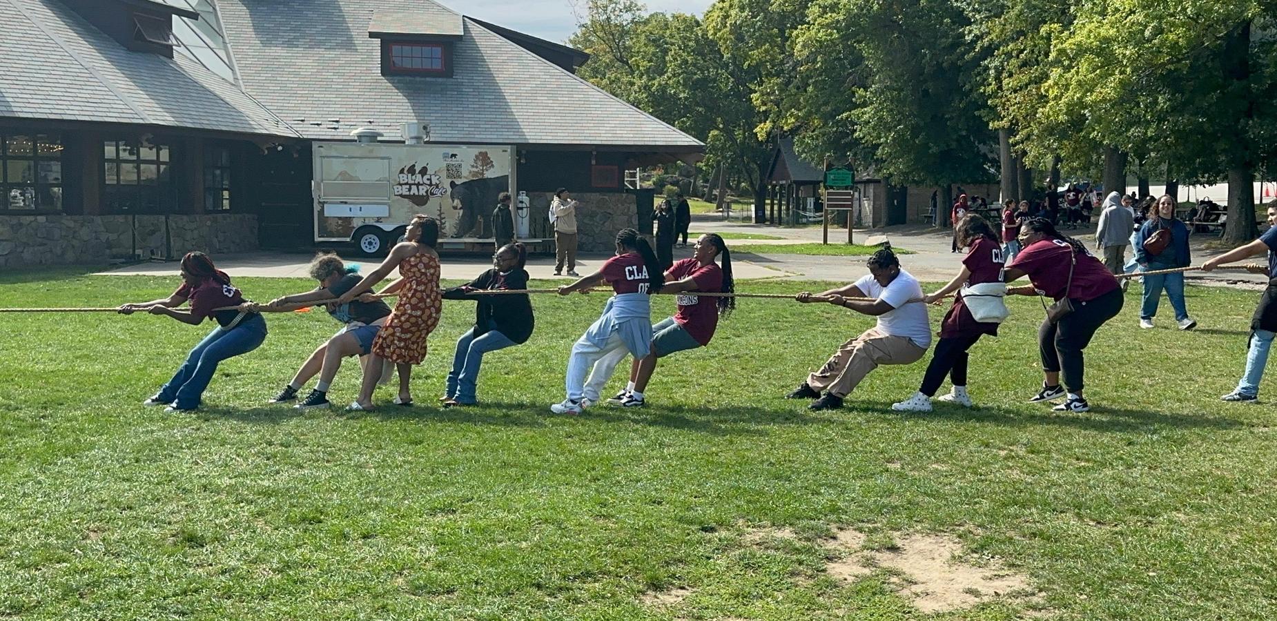 Students in a tug of war during community building trip.