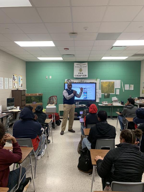 Teacher standing in front of the class discussing the new drone class.