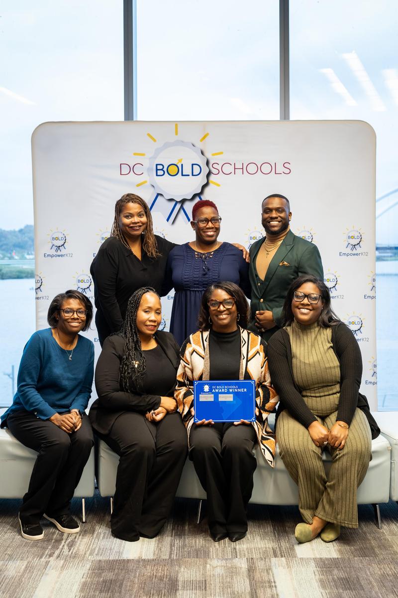 Group picture of staff holding the BOLD plaque