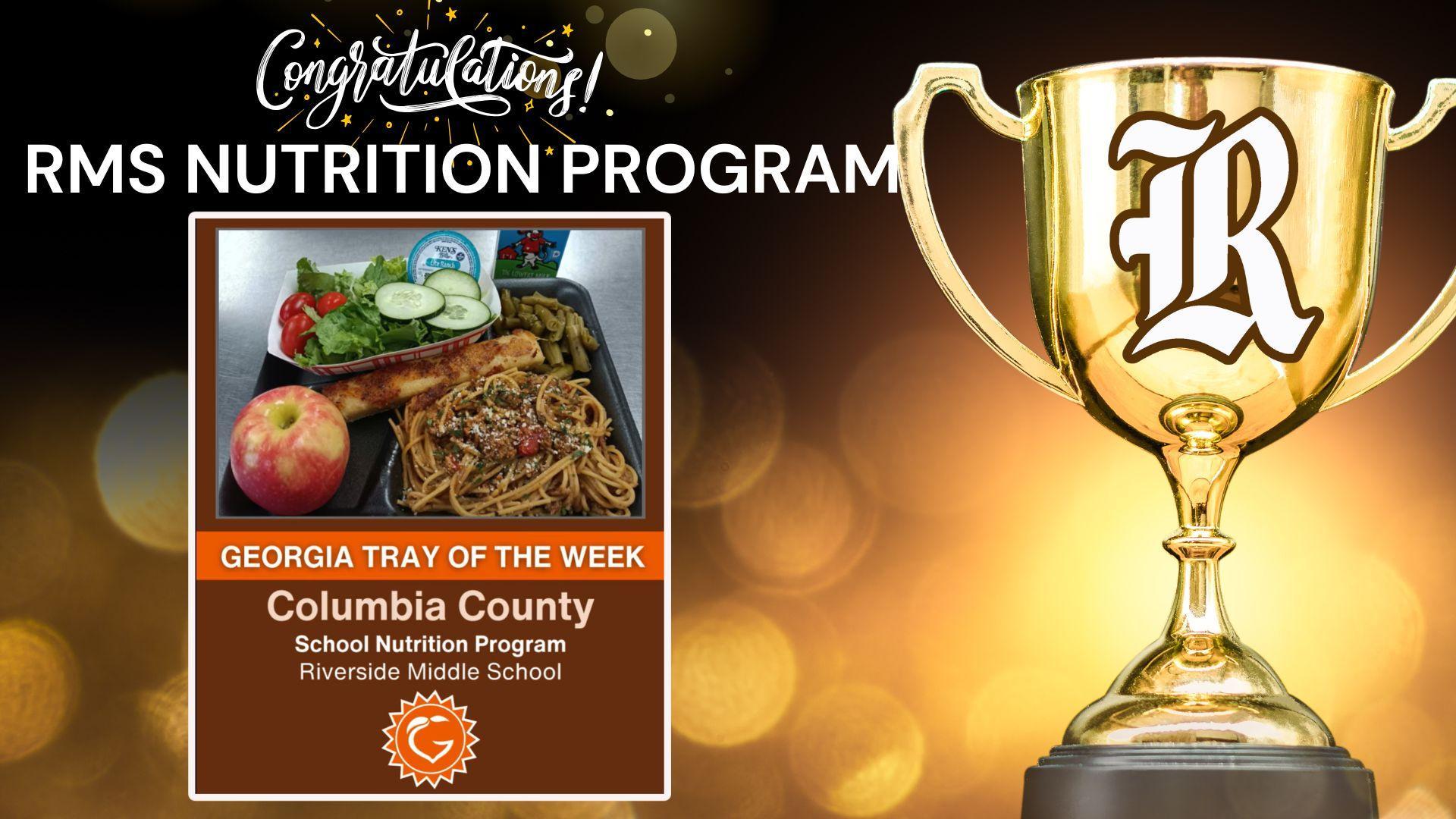 A golden trophy in front of a blurred festive background, showcasing a nutrition program award.