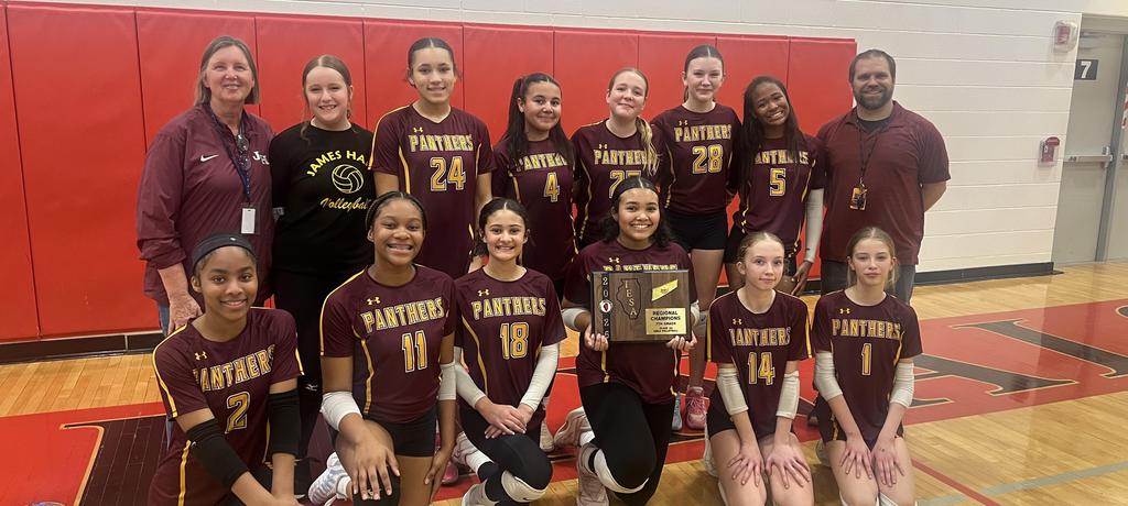volleyball team poses with winning plaque