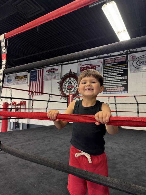 Little boy in a boxing ring