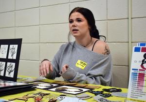 a girls sitting at a table and talking