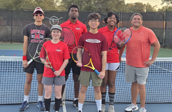 Students and coach stand on a tennis court with their rackets