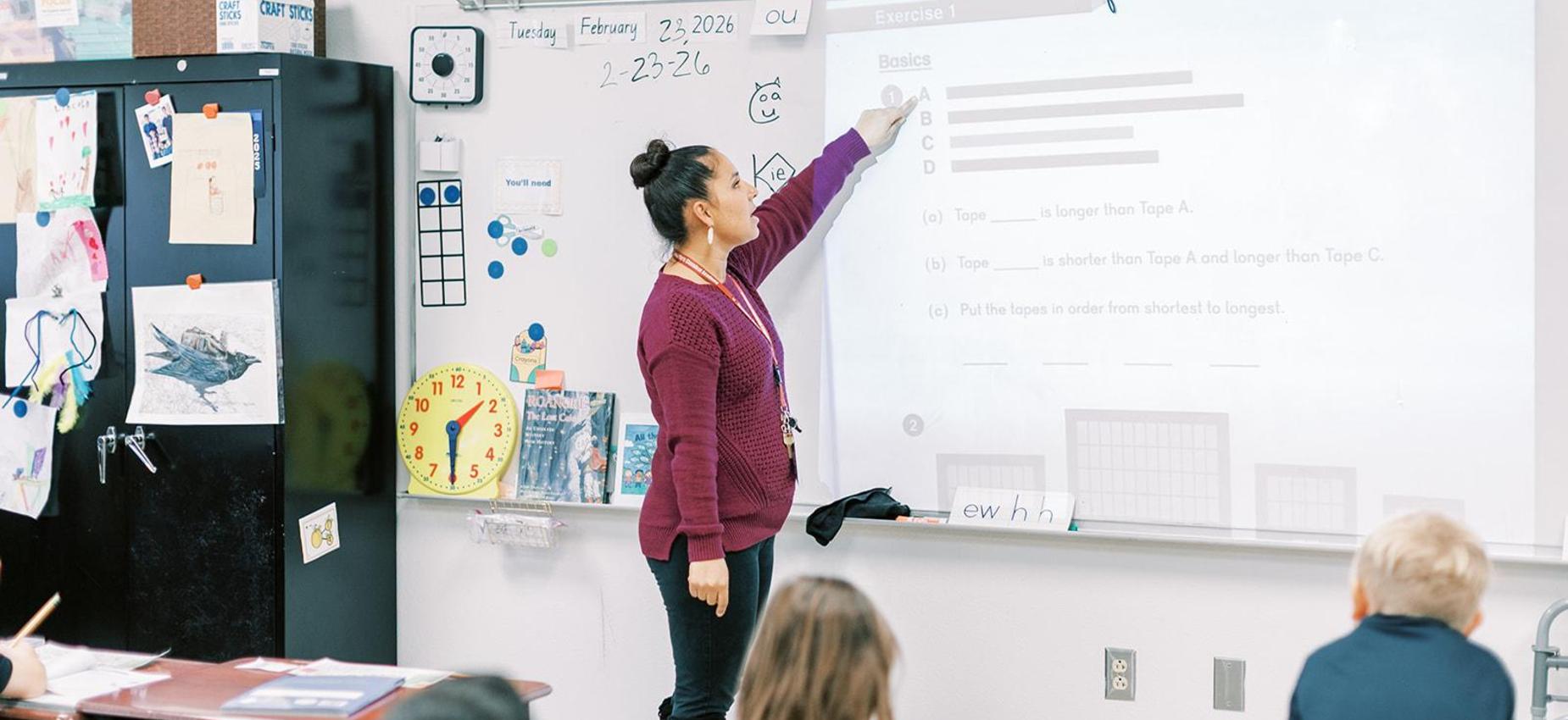 Teacher points to the whiteboard during a lesson at Founders Classical Academy &ndash; Schertz