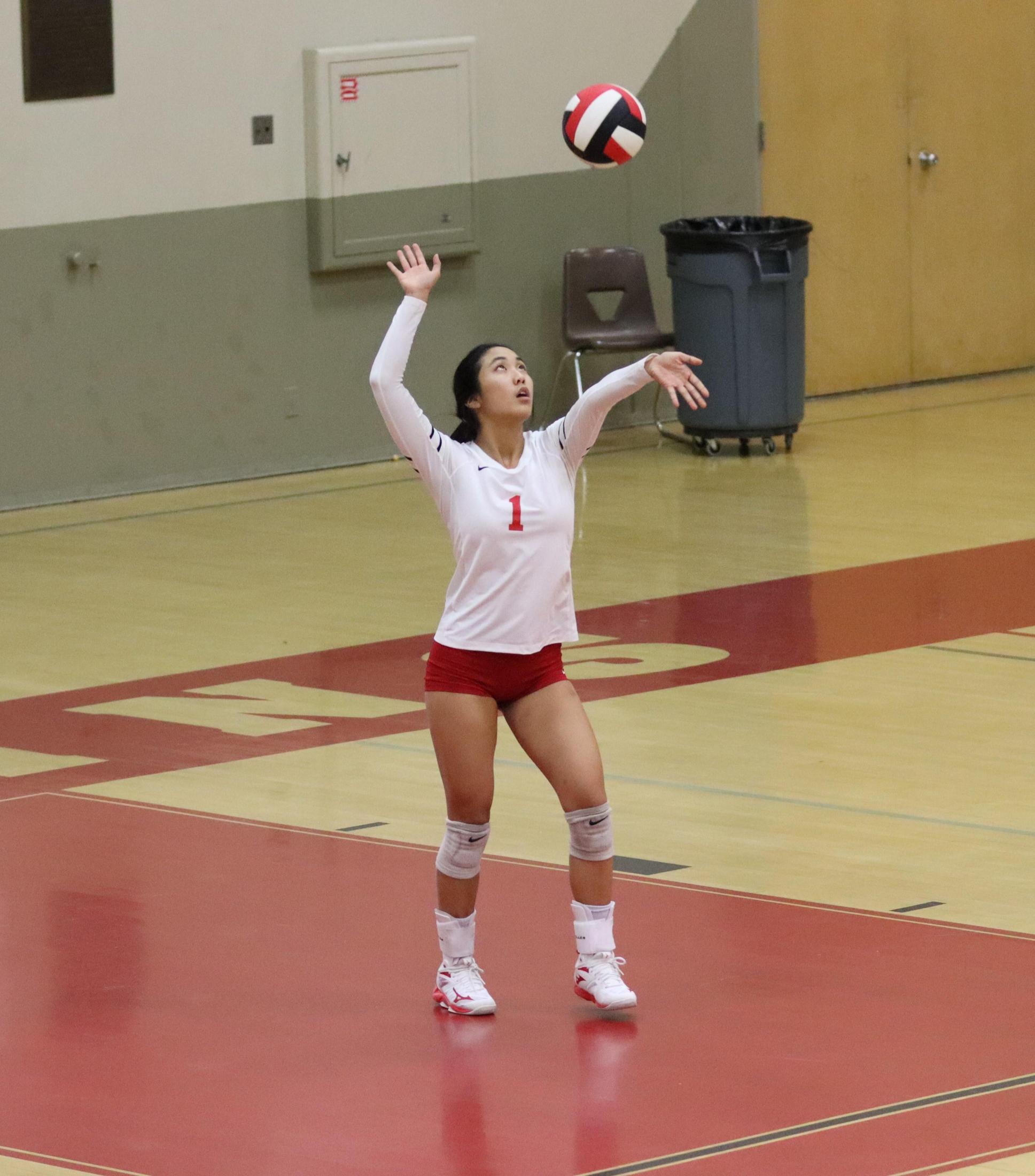 varsity volleyball players in action against liberty