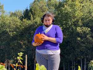 student holding pumpkin