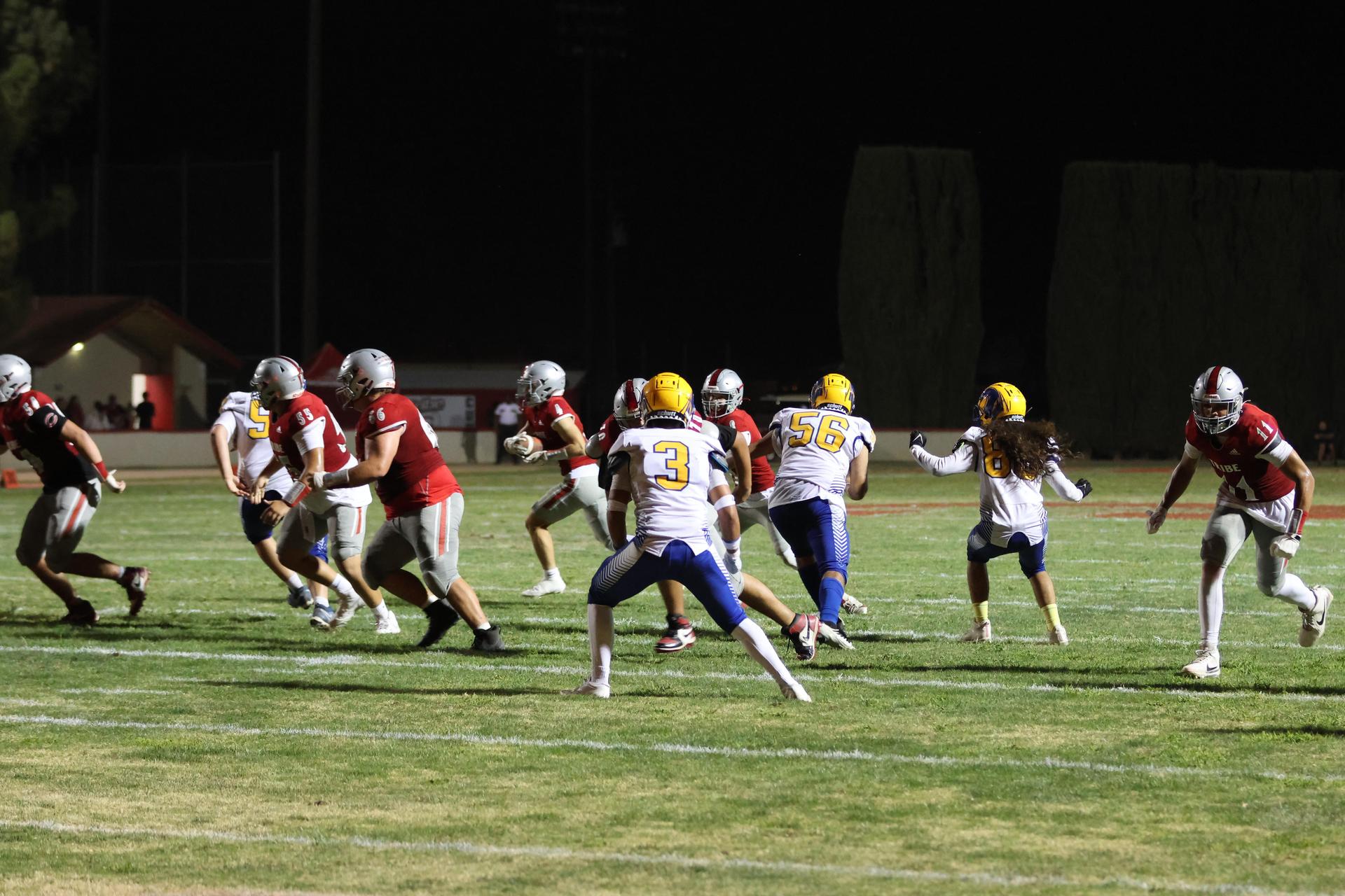 Varsity football players in action against Parlier 32