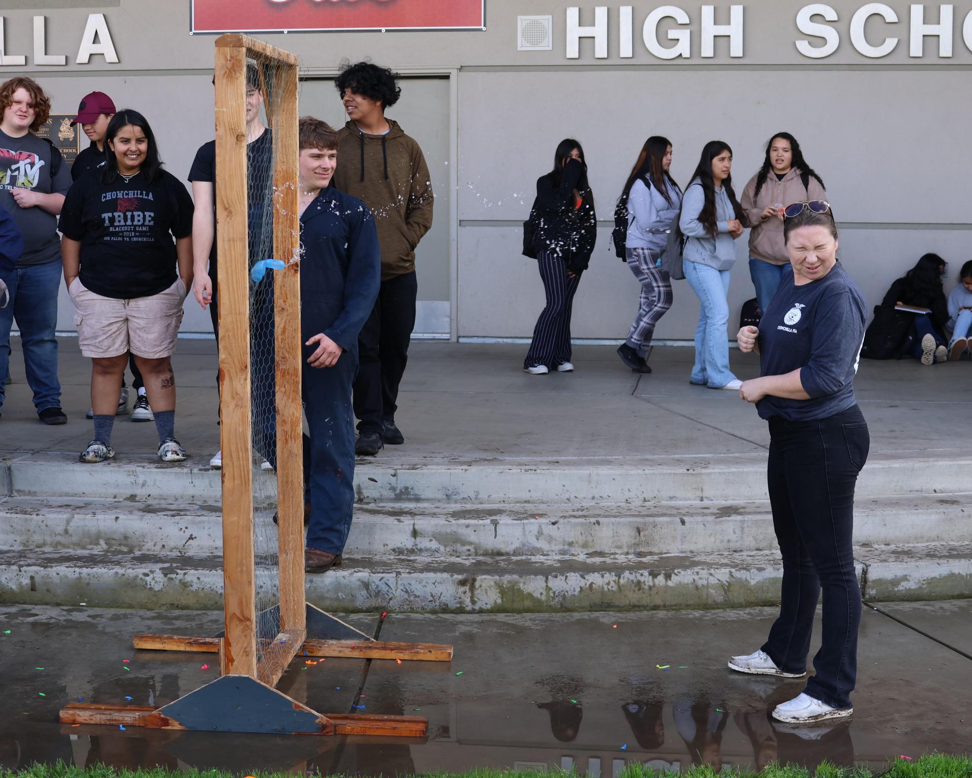 students and staff enjoying the water balloon toss