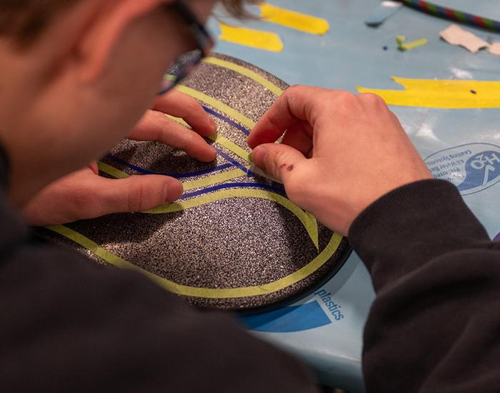 Students design and airbrush skateboards