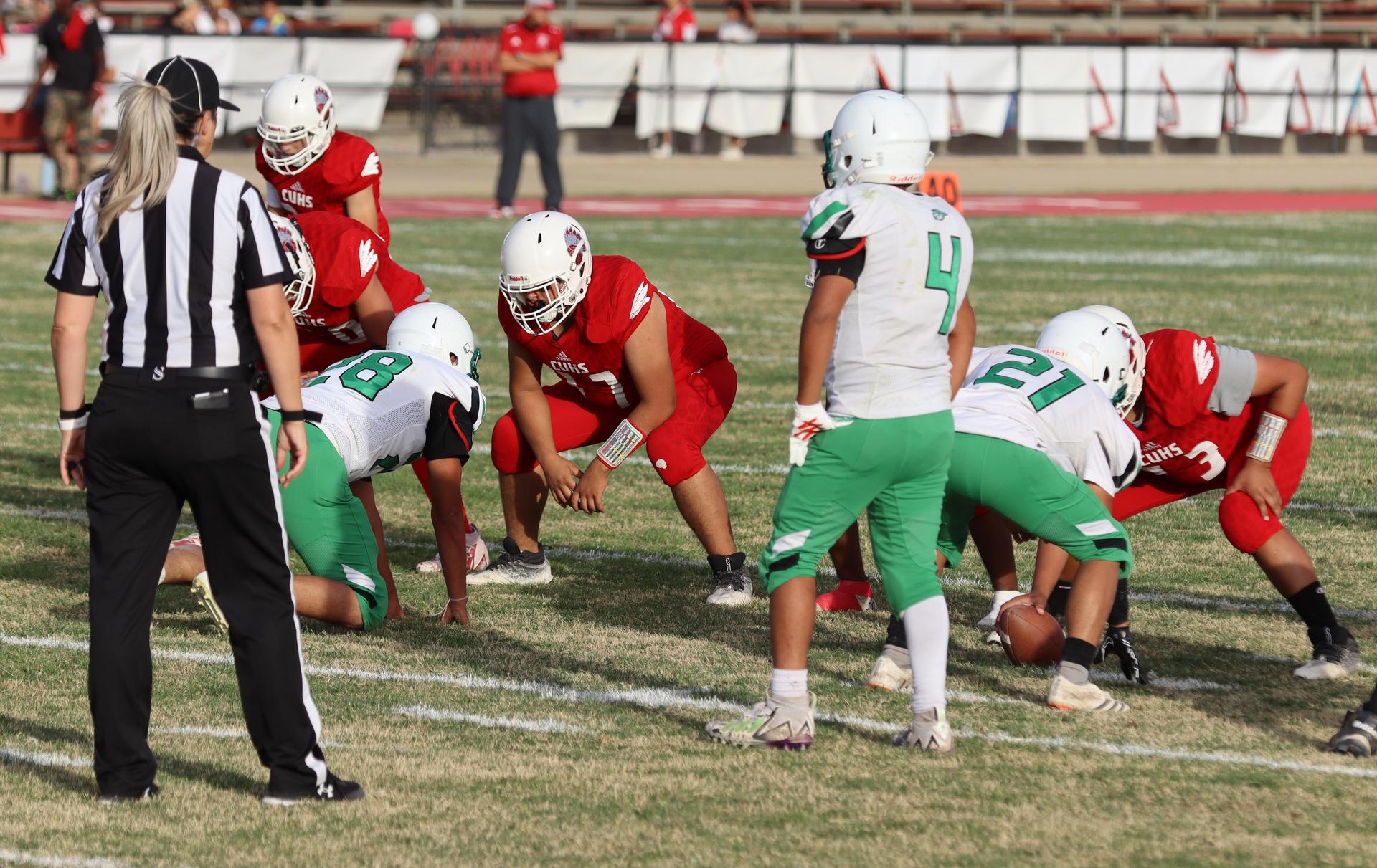  junior varsity football players in action against riverdale