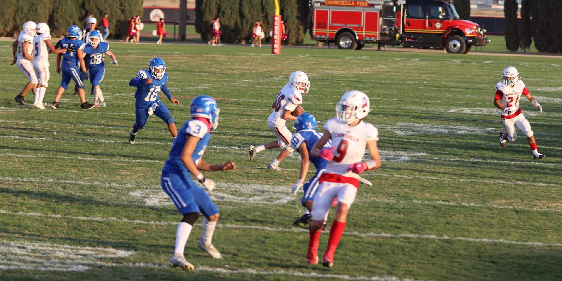 Junior Varsity football players in action against Caruthers